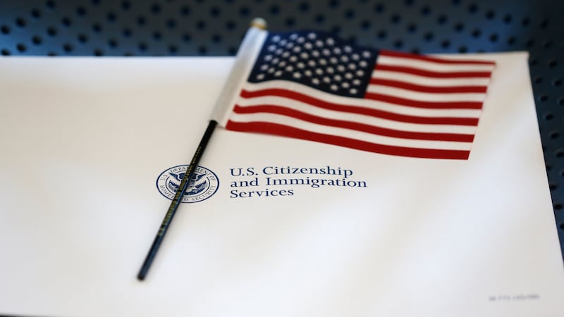 FILE - An information packet and an American flag are placed on a chair at the U.S....