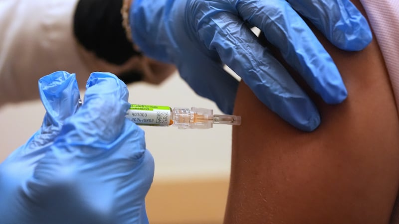 FILE - Pharmacy manager Aylen Amestoy administers a patient with a seasonal flu vaccine at a...