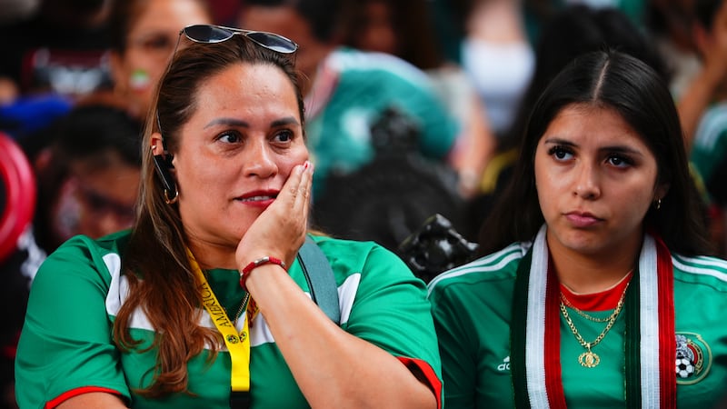 Spectators watch the opening match of the FIFA World Cup soccer tournament between Mexico and...
