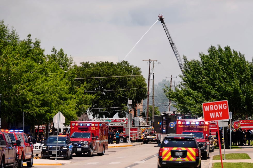 Police and firefighting crews respond to the scene of a large fire at an apartment complex in...