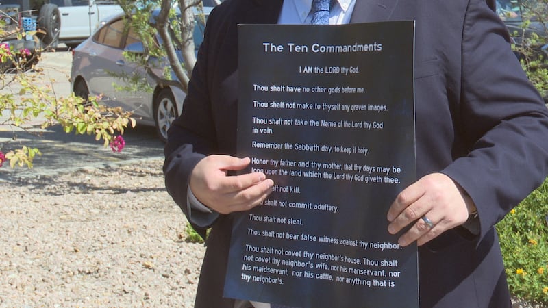 Jonathan Covey, Policy Director for Texas Values holding donated poster