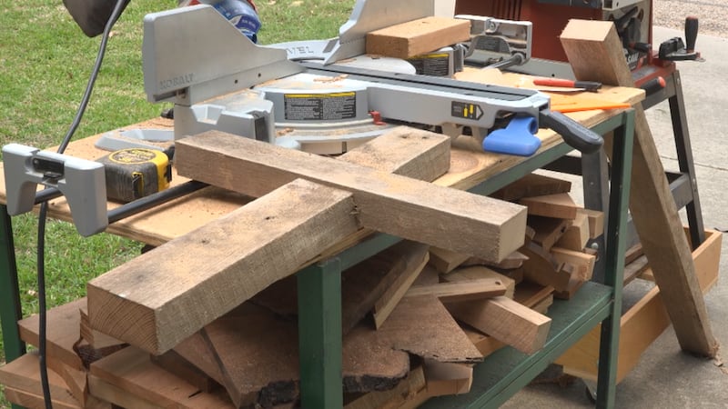 In his workshop, Aaron Rodeffer measures, saws and hammers pieces of wood into simple crosses,...