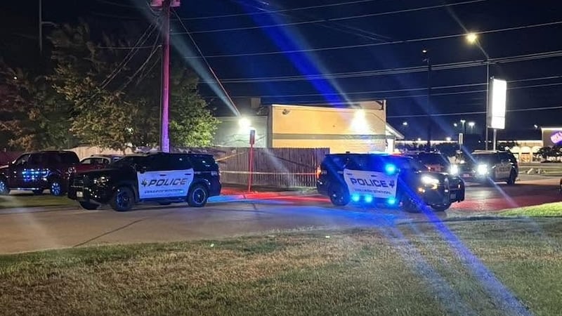 College Station police investigate the scene in the parking lot of The Grand Apartments on...