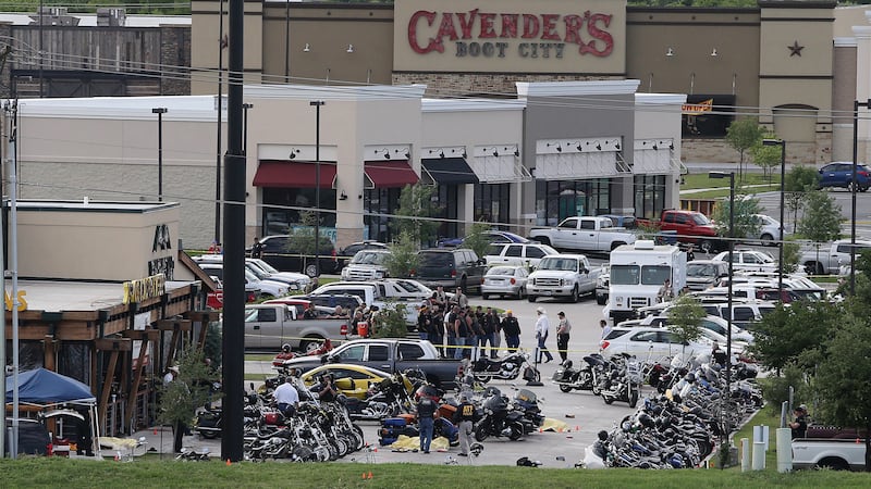 FILE - In this May 17, 2015 file photo, authorities investigate a shooting in the parking lot...